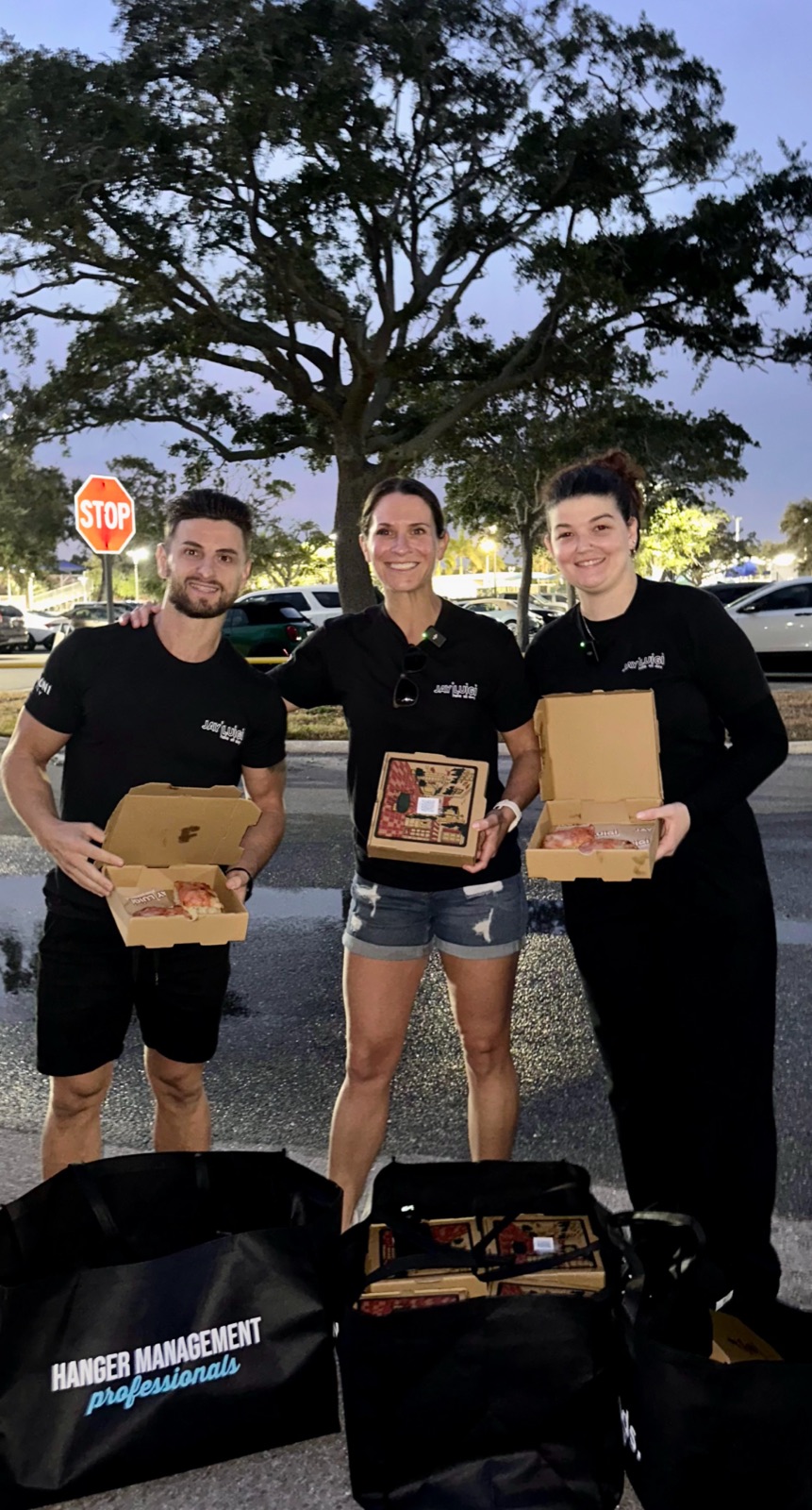 Volunteers giving out free pizzas with handwritten notes of kindness